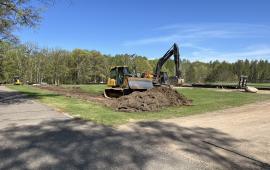 Bulldozer breaking ground on the Parking Lot