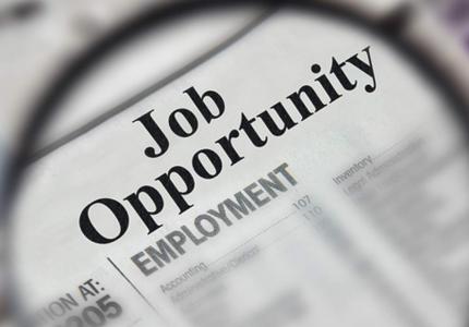 Job Opportunity Newspaper with a magnifying glass