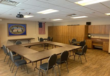 Tables and chairs arranged for a meeting in Meeting Room #2