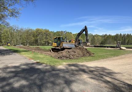 Bulldozer breaking ground on the Parking Lot