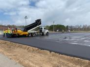 Anderson Brothers applying the bituminous wear course.