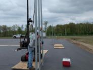 Elite Fence & Deck workers driving fence posts