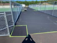 Lee Sports applying (black) base material to the pickleball social area