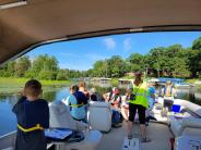 Kids on the pontoon participating in the Jr. Loon Biologist Program