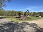 Bulldozer breaking ground on the Parking Lot