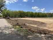 Building the parking lot sub-base and adding topsoil to the drainage ditch