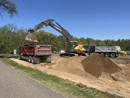 Excavating dirt for the parking lot drainage ditch